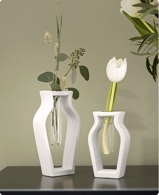 Two modern white vases with flowers